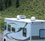 thumbnail picture of roof mounted, in-motion satellite antenna on an RV while driving down the road